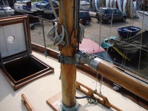 Mast with goose neck (there's a winch lever which rotates the mast to reef the sail).  Notice the absence of any halyards fed back to the cockpit.